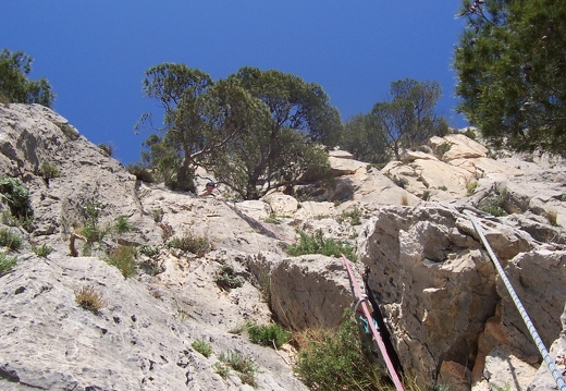 Jeanie belaying at top of 3rd pitch of Espolon Central Directa