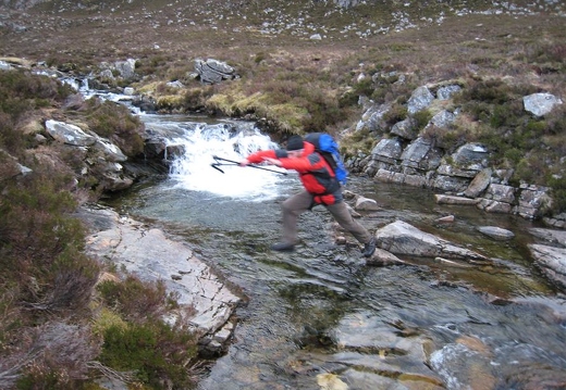 Colin leaping the stream to get back across to the access path