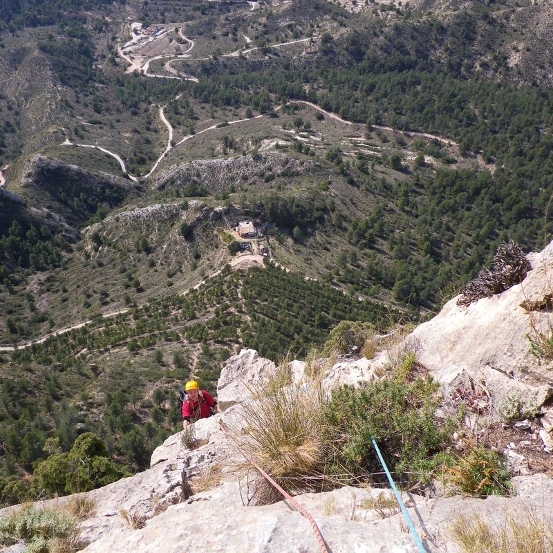 Looking down the 6th pitch of Via Gene. There's a curious cottage below, maybe a cave at the back of it?