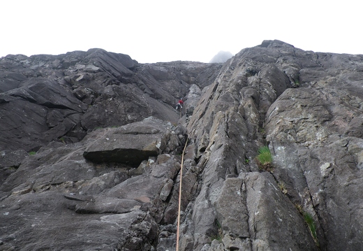 Jeanie on the 1st pitch of White Slab Direct. The white slab can be seen at the very top in the mist.