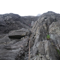 Jeanie on the 1st pitch of White Slab Direct. The white slab can be seen at the very top in the mist.