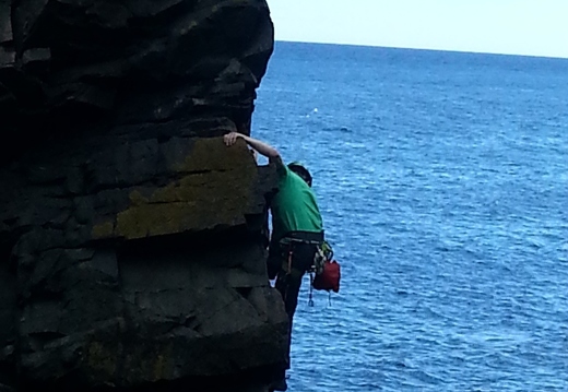 A young Edinburgh climber on the bad step round the arete to the bottom of Ordinary Route