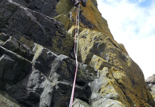 Sam on the initial awkward groove of Ordinary Route (HVS 5a)