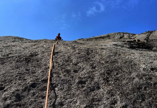 Topping out on an easy slab of impeccable granite (Pitch 4)
