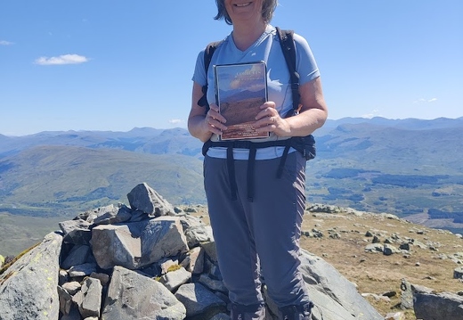 e A happy hillwalker with an unneeded book